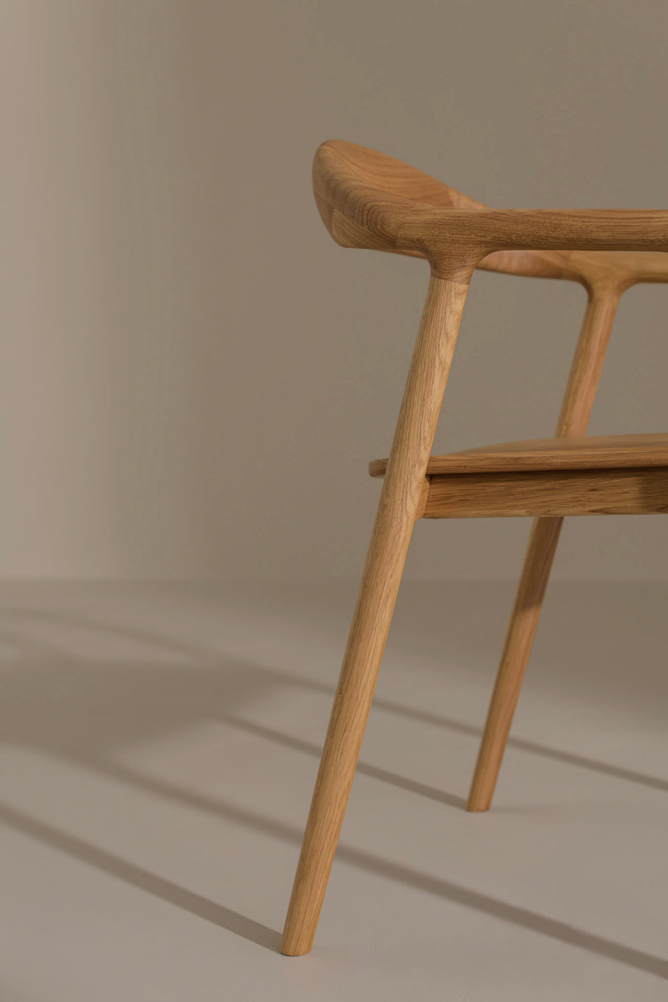 Tapered legs enhance the elegant yet grounded form.